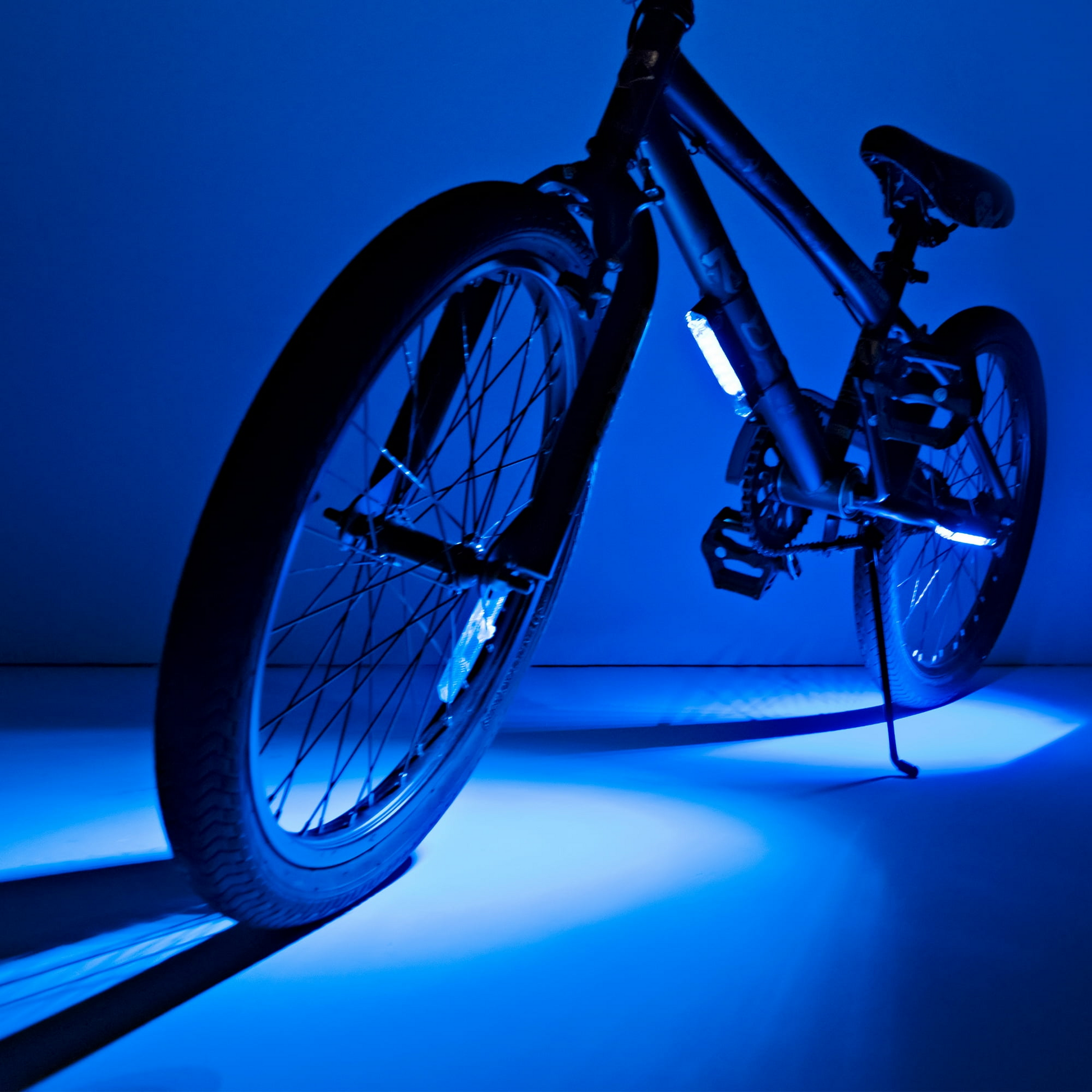 A bicycle glows vibrantly in blue against the dark, thanks to Go Brightz by Brightz, casting its brilliant LED magic with ease.