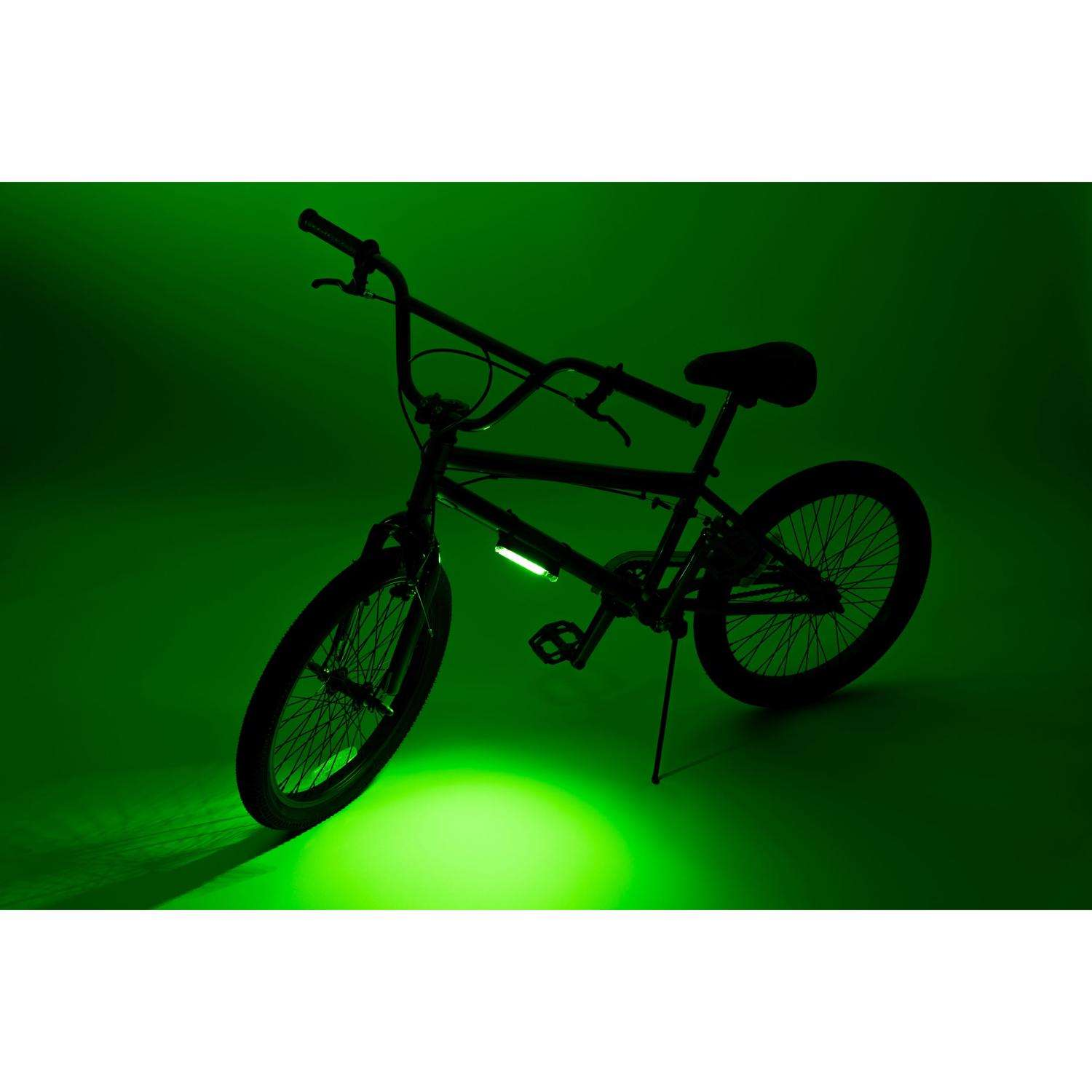 The Go Brightz LED bike wheel lights by Brightz light up the scene against a dark green background, creating a captivating glow.