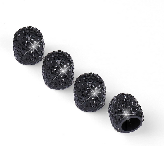 Four Color Splash Valve Gems – Onyx, black rhinestone-studded valve caps, are arranged in a row on a white background; one reveals its hollow interior.