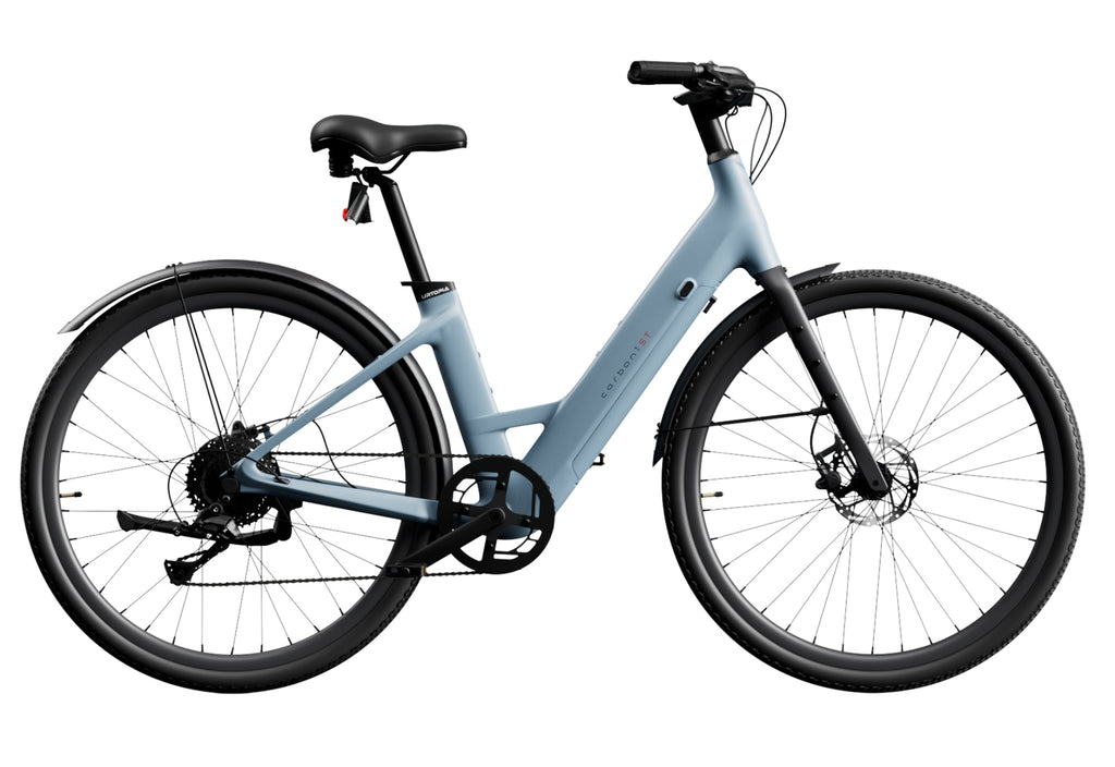 A light blue Urtopia - Carbon 1 Step-Thru ultra-light electric bicycle, featuring a step-through frame, disc brakes, and black handlebars and tires made from Toray carbon fiber, is displayed on a white background.