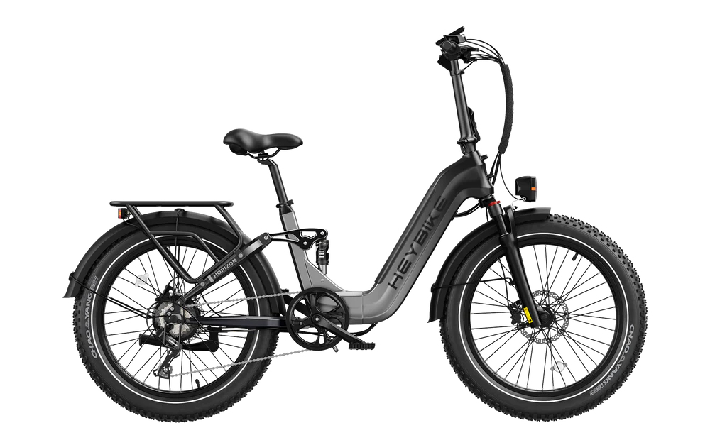 HeyBike - Horizon electric folding bicycle with fat tires and rear cargo rack, isolated on a black background.