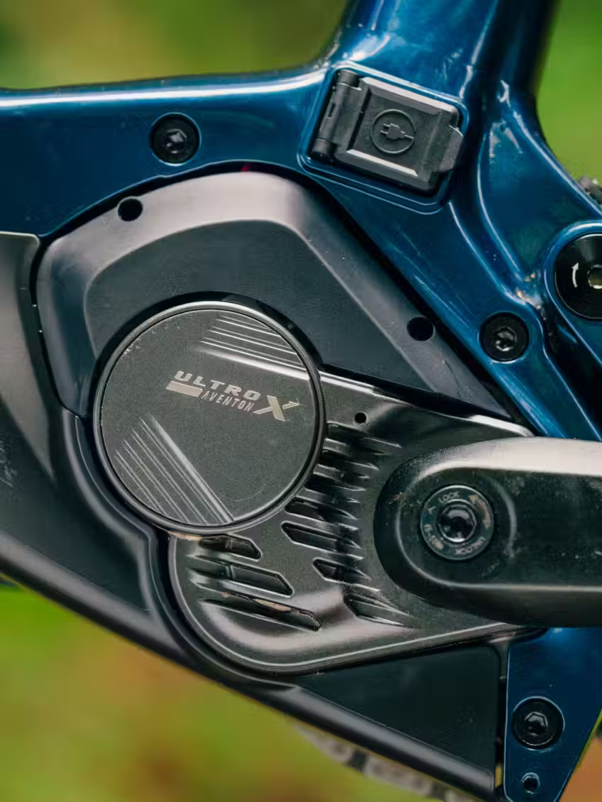 Close-up of an Aventon Current ADV motor mounted on a blue electric mountain bike frame by Aventon.