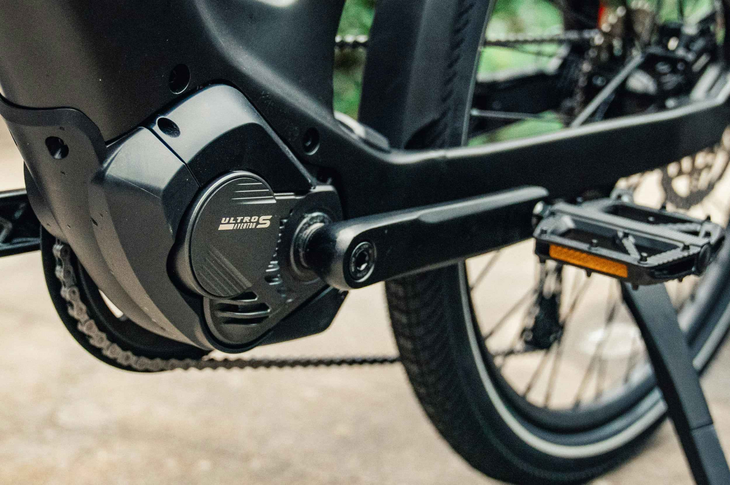 Close-up of the Aventon Level 4 ADV’s motor and pedal crank, showing the "Ultra S Version 1" label on the mid-drive electric bike from Aventon.