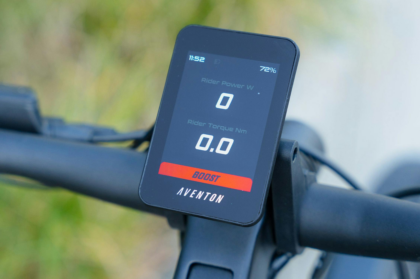 A close-up of the Aventon Level 4 REC electric bike display shows rider power and torque at zero, with "BOOST" mode highlighted—showcasing the Aventon’s powerful hub motor ready for action.