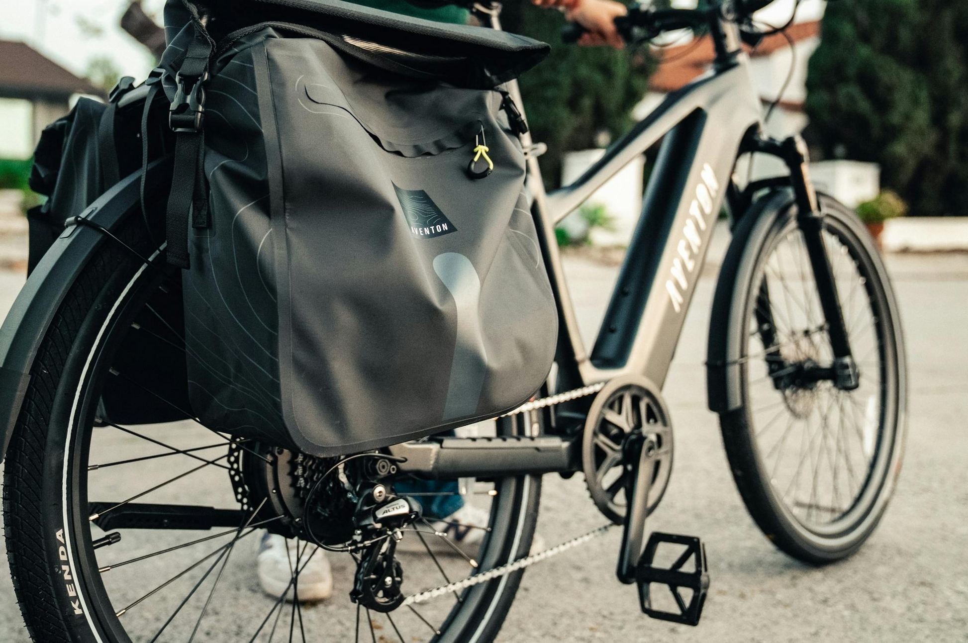 Close-up of the Aventon Level 4 REC electric bike by Aventon, featuring a large pannier bag on the rear wheel. Its strong hub motor is ideal for urban commuting and transporting extra gear.