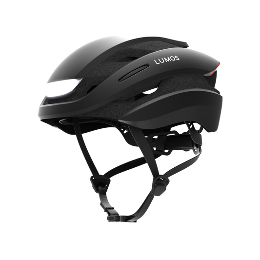 A modern Lumos Ultra MIPS Helmet with integrated lights, MIPS Technology, and a chin strap, isolated on a black background.