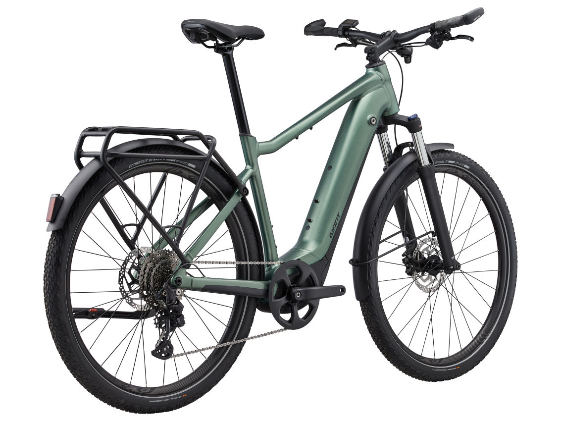 An electric Giant - Explore E+ 1 DD adventure bike bustling with green energy, set against a crisp and clean white background.