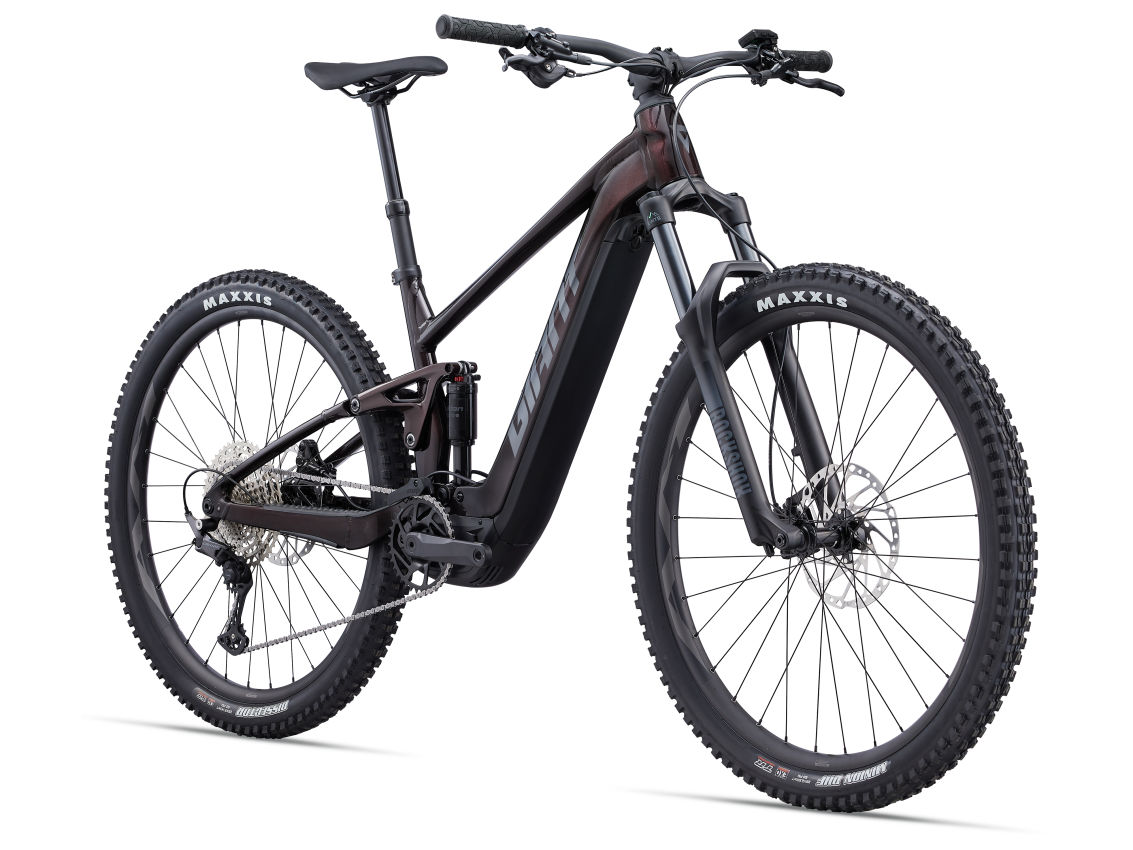 A modern Giant - Stance E+1 Pro electric mountain e-bike with a black frame and maxxis tires, displayed against a white background.