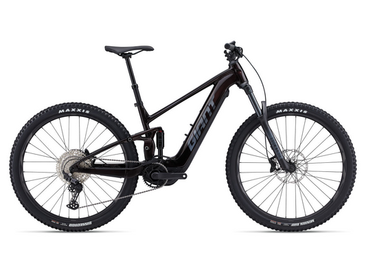 A black Giant Stance E+1 Pro electric mountain bike with thick tires and a powerful motor, isolated on a white background.