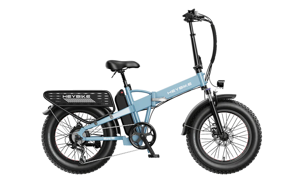 HeyBike Mars 2.0 electric folding bicycle in blue and black, featuring thick tires, a rear rack, and a backlit display with hydraulic brakes, isolated on a striped background.