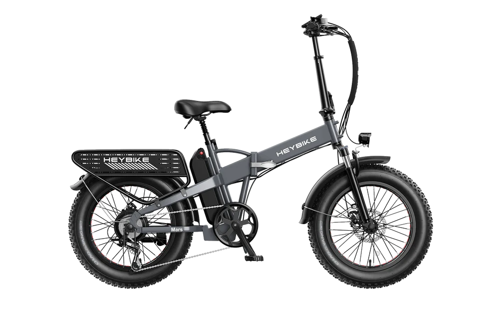 A black HeyBike Mars 2.0 folding electric bicycle with fat tires, mounted on a black and white striped background.