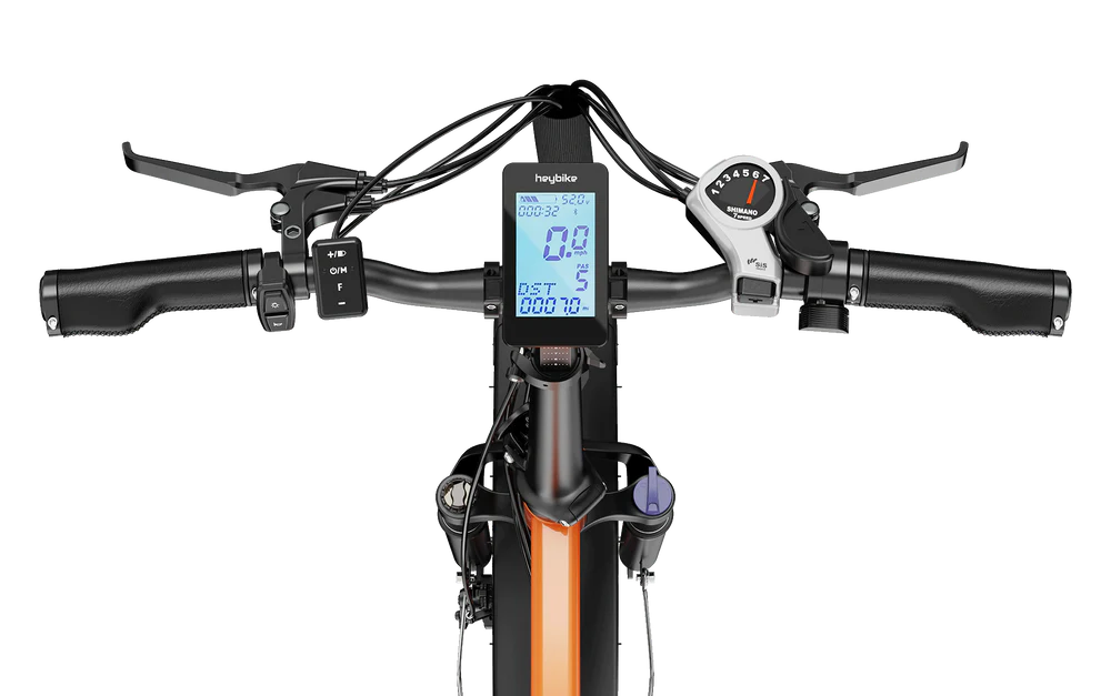 Close-up view of a HeyBike Mars 2.0 fat tire ebike's handlebar and dashboard, showing speedometers and other control features.