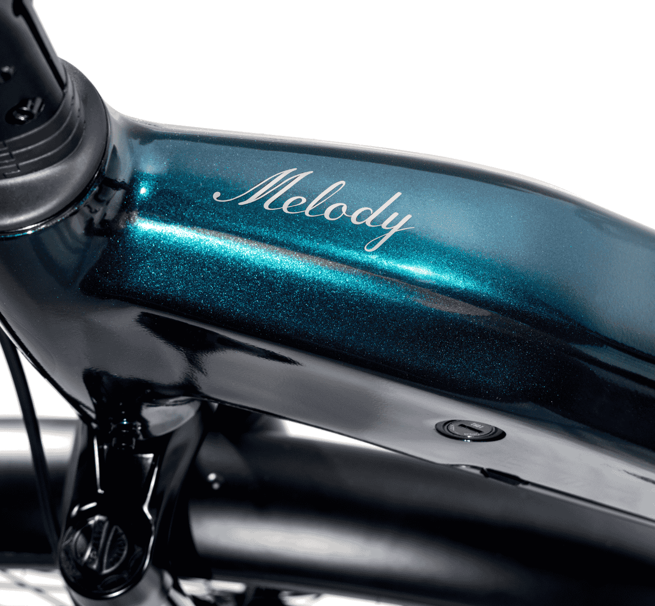 Close-up of a teal Magnum Melody electric bike frame by Magnum, featuring "Melody" in cursive on the top tube.