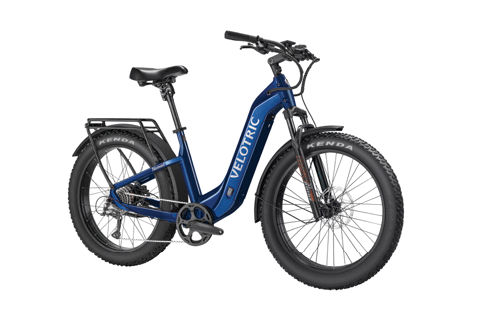 Discover new horizons with the Velotric - Nomad 2, an all-terrain eBike featuring a sleek blue frame and durable black tires. Ideal for adventure seekers, it has a rear rack for gear and front suspension for smooth rides, making it your gateway to thrilling journeys.