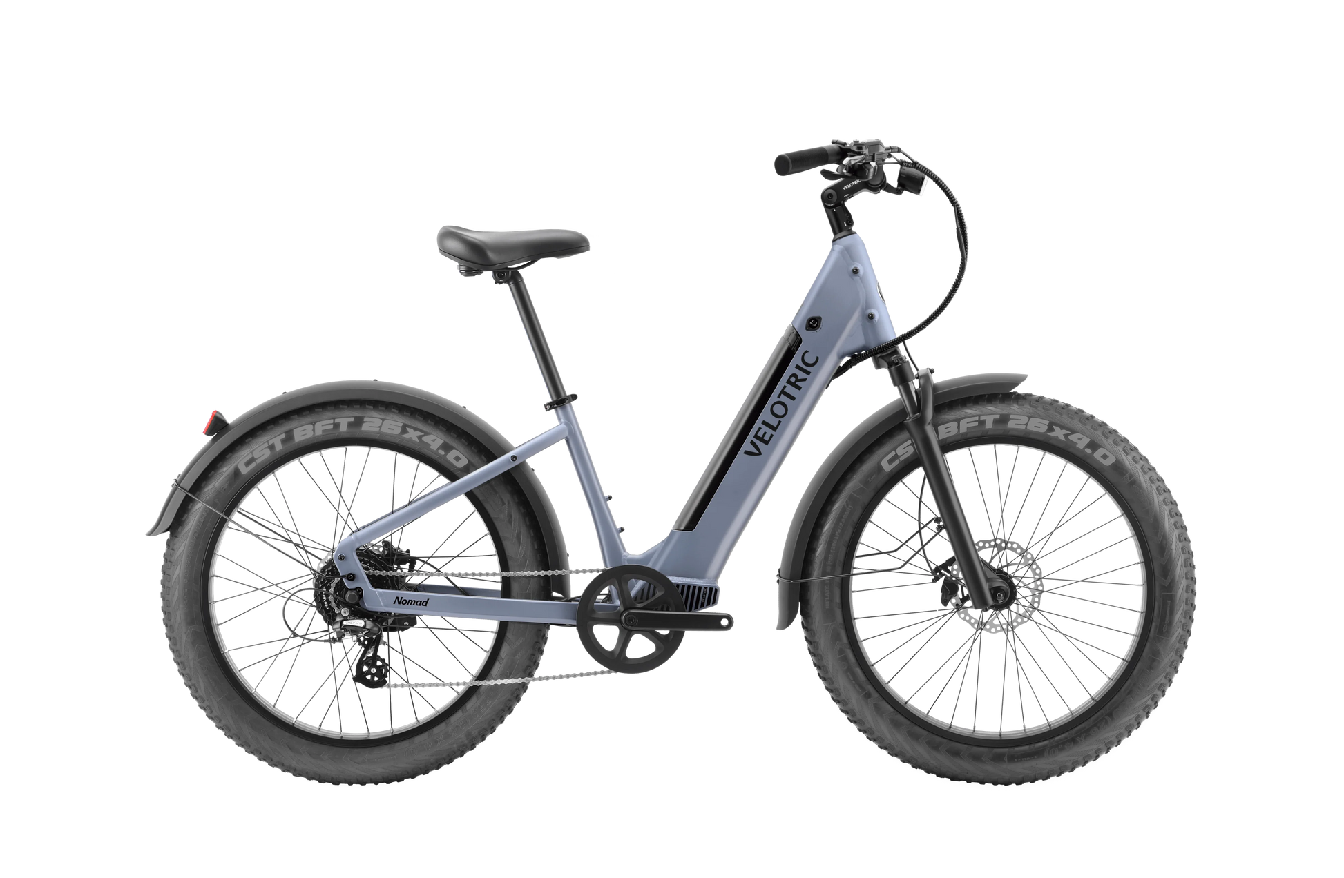 The Velotric Nomad 1 Plus is a blue commuter e-bike featuring thick tires, a step-through frame with "Velotric" branding, and powered by the efficient Velopower H50 drive system, viewed from the side.