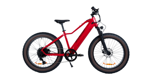 The Magnum - Edge by Magnum is a red fat-tire electric bike with a front suspension fork, disc brakes, and knobby tires, shown in side profile on a white background and built for high-performance adventures.