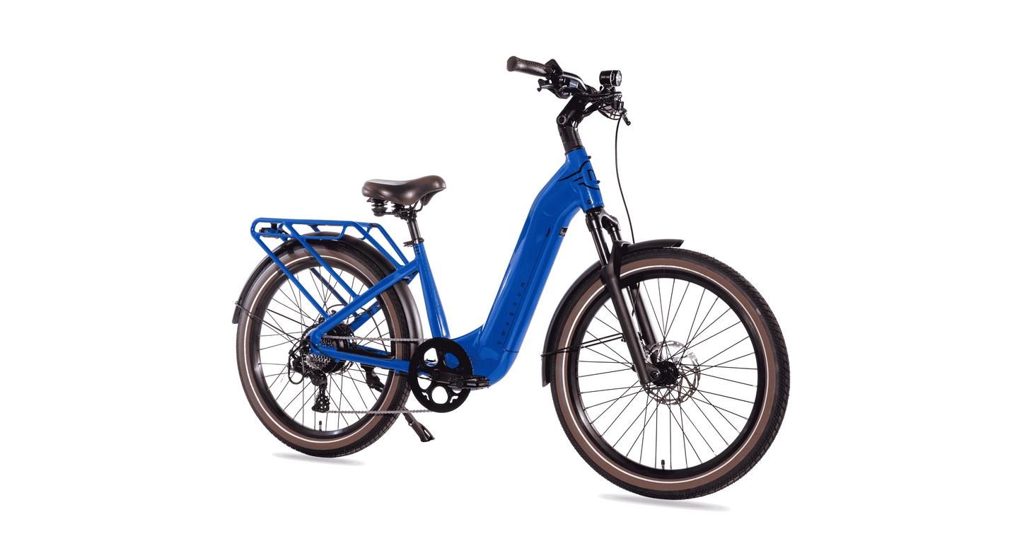 The Magnum Melody by Magnum is a blue electric bike with a low-step commuter frame, rear cargo rack, front and rear fenders, and wide tires, shown from the side on a white background.