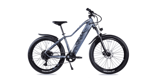 Side view of the Magnum Peak 2.0 electric mountain bike by Magnum, featuring thick tires, front suspension, rear mudguard, and advanced torque sensor, isolated on a white background.