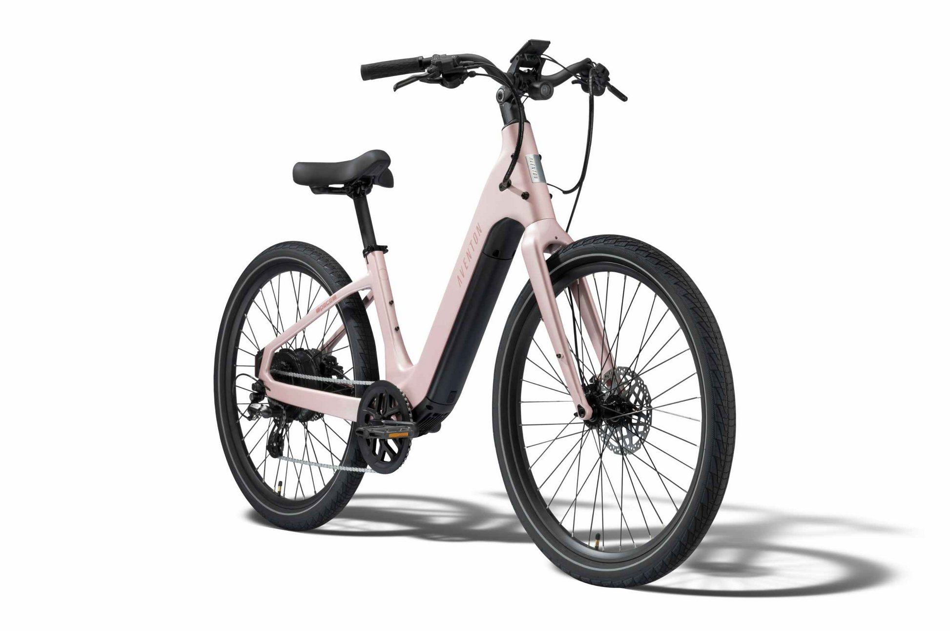 The Aventon Pace 5 REC Step-Through by Aventon is a light pink electric bike with flat handlebars, an integrated battery, and disc brakes—ideal as a comfort cruiser for smooth, effortless rides.