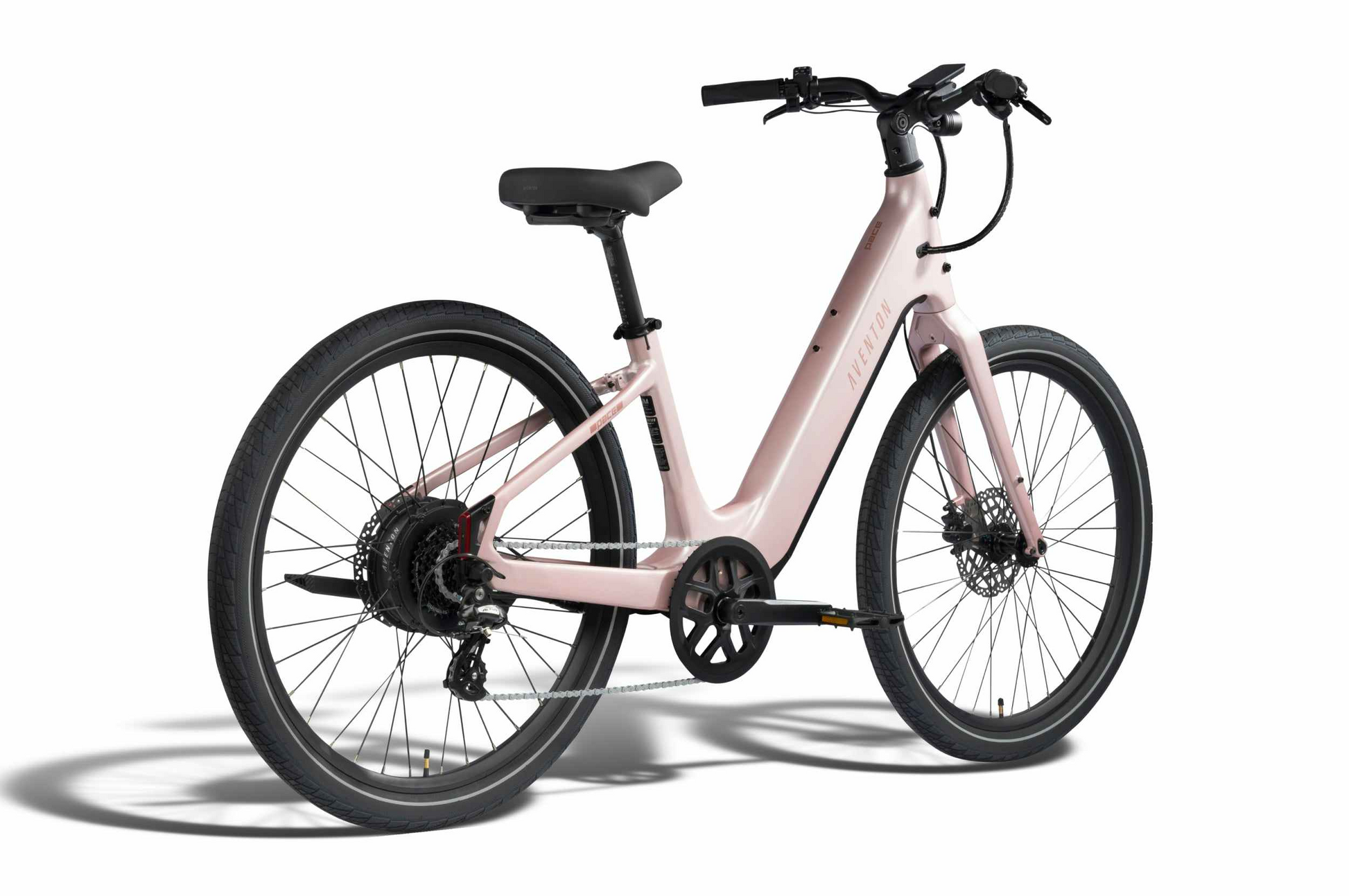 The Aventon Pace 5 REC Step-Through by Aventon is a light pink comfort cruiser e-bike featuring black tires, a gear system, and a rear hub motor, shown on a white background.