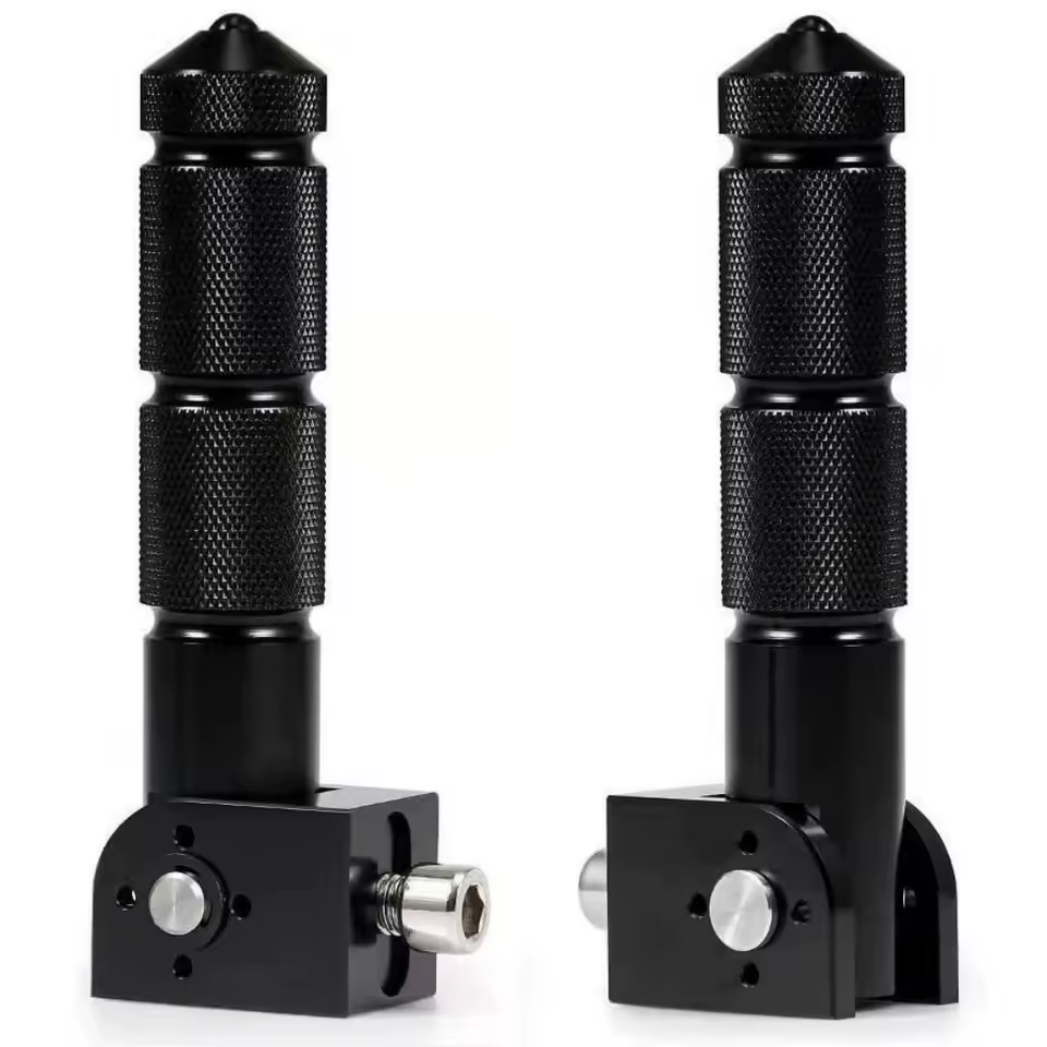 Two black Color Splash Rear Pegs (Copy), crafted from CNC aluminum with textured grips and included mounting hardware, designed as folding eBike rear pegs, are displayed from various angles on a white background.