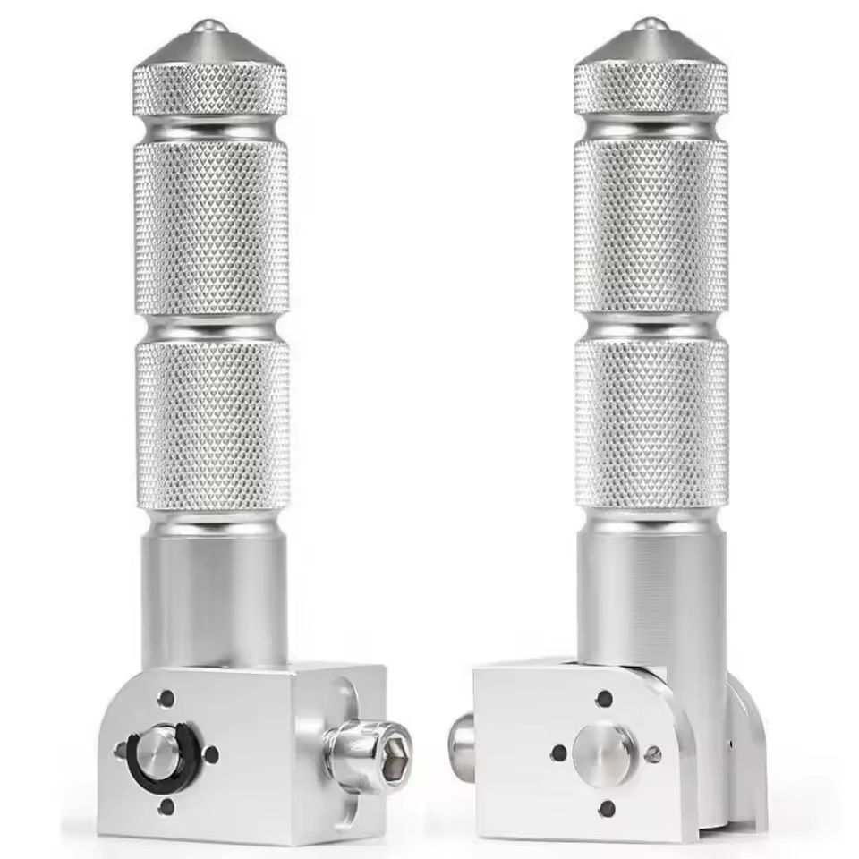 Two Color Splash Rear Pegs in silver metal are displayed upright on a white background, featuring textured grips. The visible mounting bases and hardware at the bottom highlight their versatility as rear pegs or as an eBike footrest.