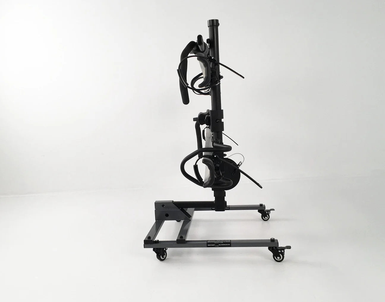 The Hollywood Racks Rack Valet, a black vertical stand with wheels, securely holds a fat-tire bike frame and handlebars upright against a plain white background.