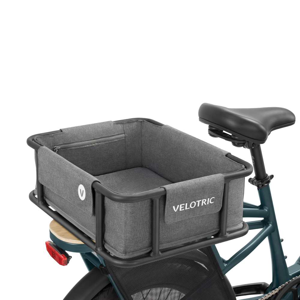 Rear view of a bicycle equipped with a Rear Basket 2.0 - M - Velotric, featuring a gray fabric cargo basket with waterproof lining and labeled "Velotric," positioned behind the seat.