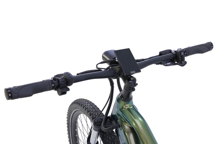 Close-up of AIMA - Rocky e-bike handlebars with mounted controls and display, featuring part of the front tire and frame against a white background.
