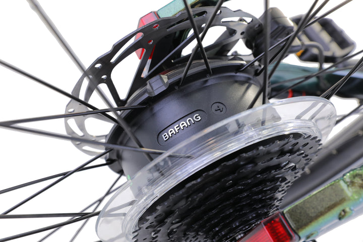 Close-up of the AIMA - Rocky’s Bafang electric motor hub on a rugged e-bike wheel, showcasing spokes, gears, and part of the disc brake.