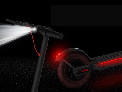 The Hiboy - S2 Pro Electric Scooter is shown at night with headlights on the handlebar and red lights on the rear wheel and deck glowing, perfect for daily commuting. Its high-performance motor ensures a smooth, reliable ride anytime.