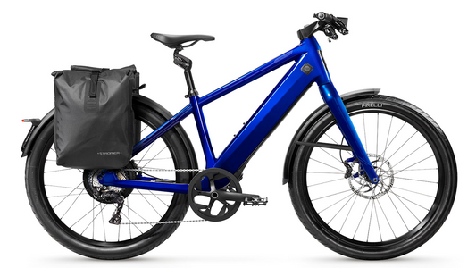 eBike: Blue Stromer ST3 Limited Edition electric bicycle with attached rear pannier bag, disc brakes, and black tires on a white background.