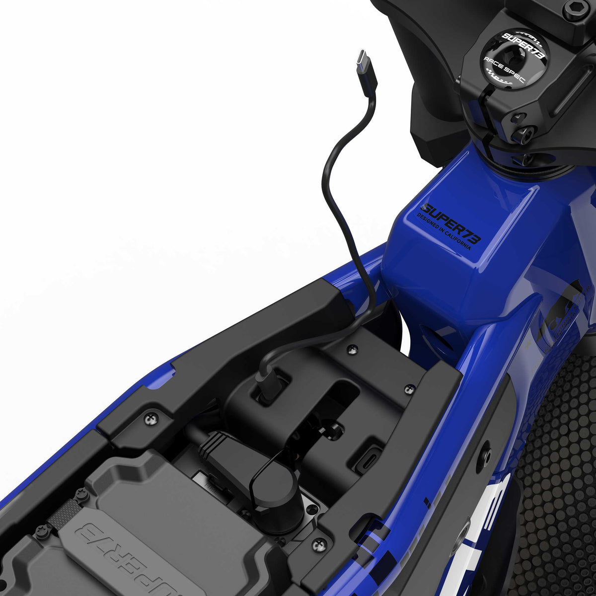 Close up inside the battery and storage compartment showcasing USB-C charging capabilities of the Oracle Red Bull Racing M1D SE ebike in Nightfall Blue.
