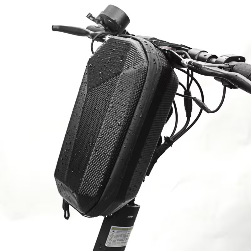 A Tampa Bay eBikes Bag for Scooter, in black and designed to be water-resistant, is mounted on the handlebars of an electric scooter, with visible water droplets on its surface.