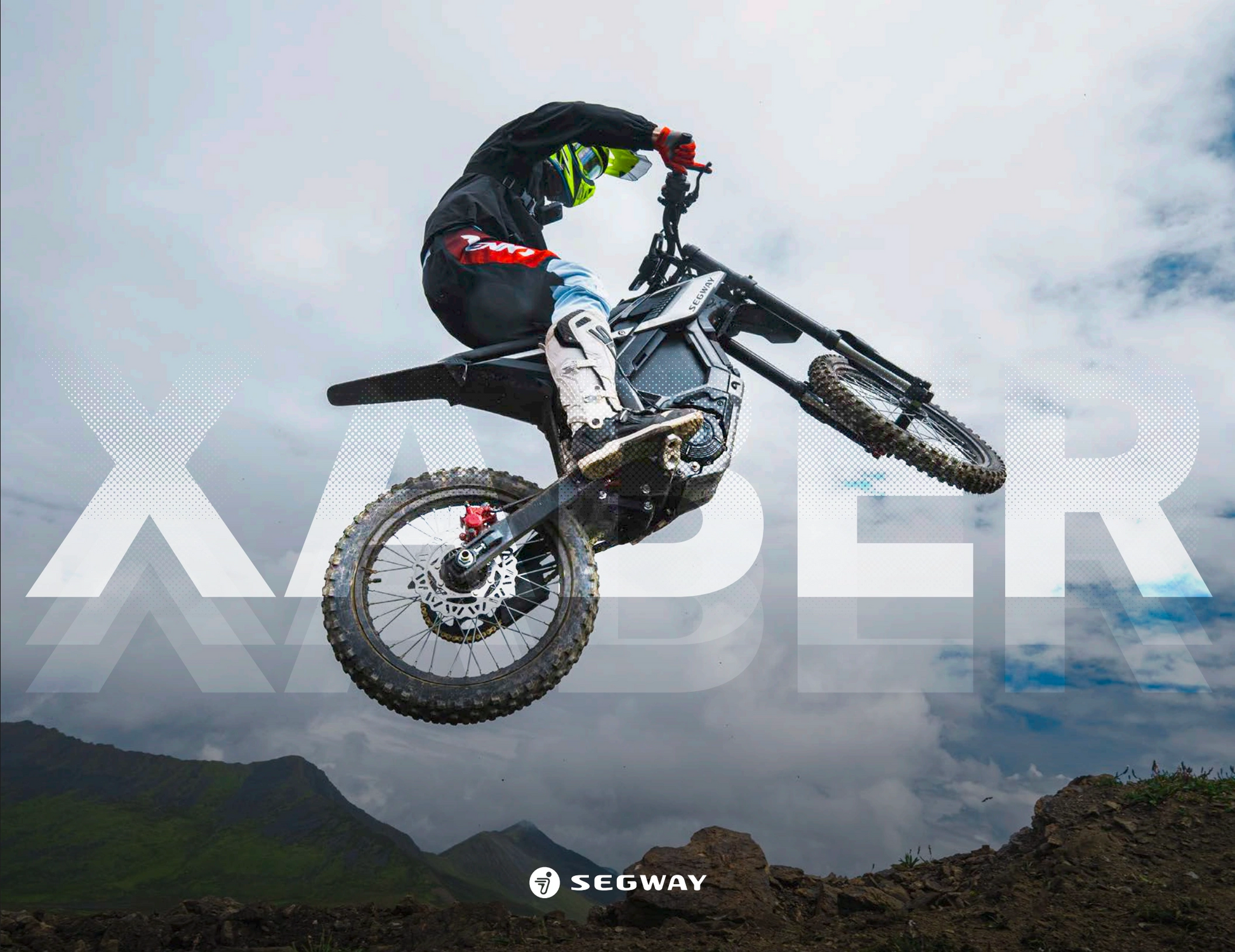 Rider on a Segway Xaber 300 electric dirt bike soars off-road before a cloudy sky, with "XABER" and the Segway logo behind, emphasizing the Segway Xaber 300's bold off-road performance.