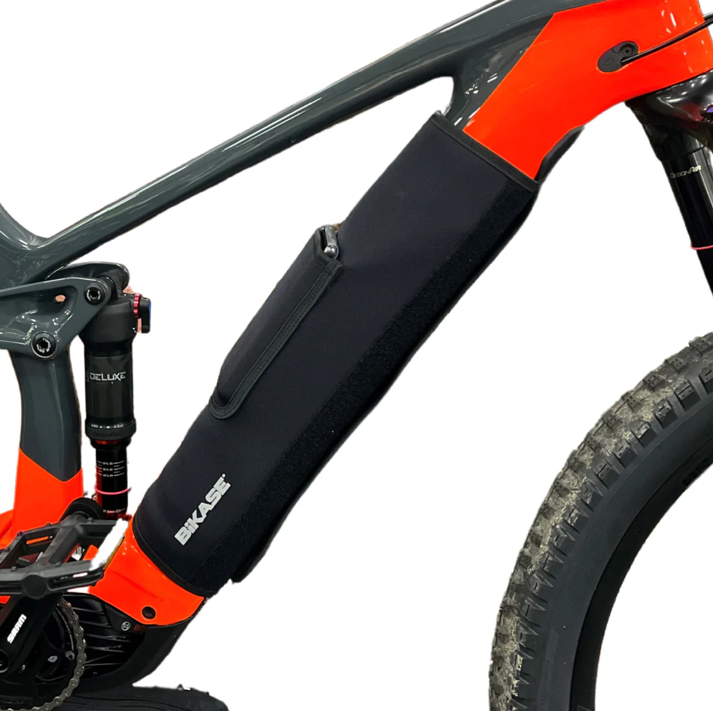 A close-up image showcases a partial bicycle frame fitted with the eBike Battery Cover by Bikase, a black, zippered neoprene cover on the lower tube. The cover, featuring the logo "Bikase," offers robust battery protection and insulation.