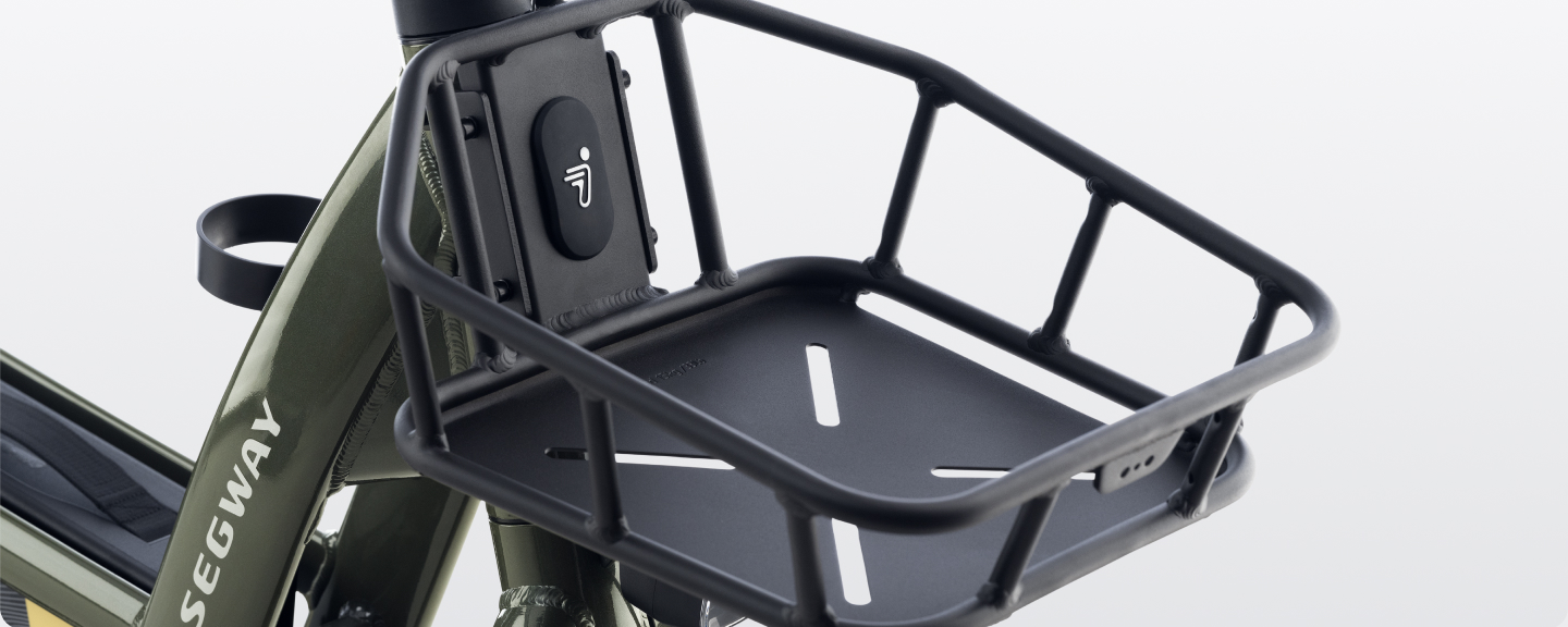 Close-up of the Segway Front Basket by Segway, mounted on the frame of an olive green Segway bicycle, showcasing this practical e-bike accessory.
