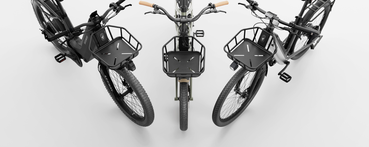 Three black bicycles with Segway brand Segway Front Basket accessories are arranged in a semi-circle on a white background, viewed from above.
