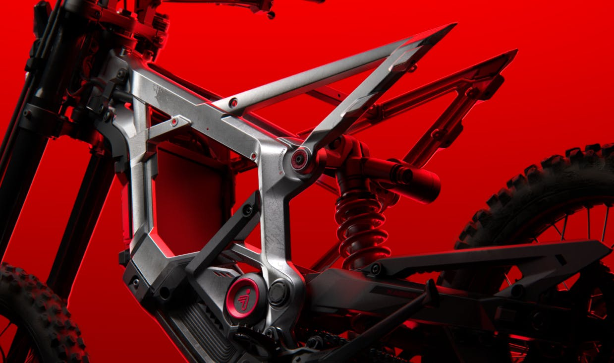 Close-up of the Segway Xaber 300 electric mountain bike frame by Segway, featuring exposed suspension and an angular metal design, set against a striking red background.