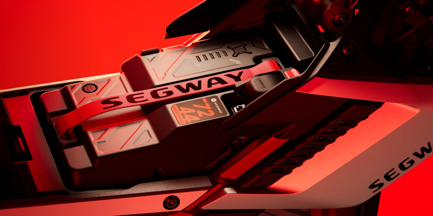 Close-up of the Segway Xaber 300 electric dirt bike's branded battery compartment against a red background, showcasing Segway's innovation in high-performance electric bikes.