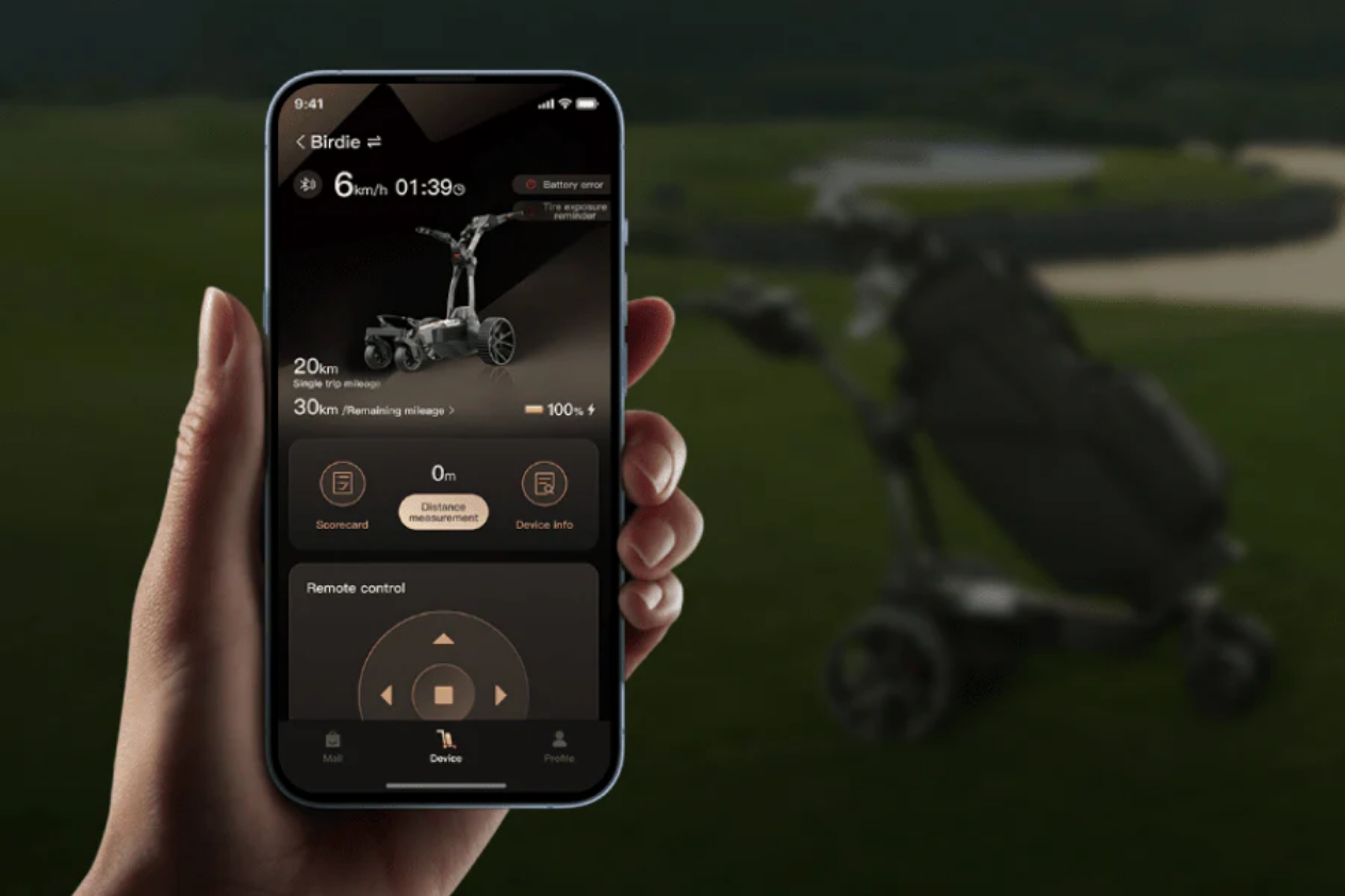 A hand holds a smartphone showing the Navee Birdie 3X control app by Navee, with a blurred electric golf push cart and Tampa Bay golf greenery in the background.