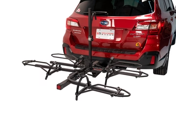 A red suv with a Hollywood Racks - Trike Adapter Kit For Sport Rider attached to it.