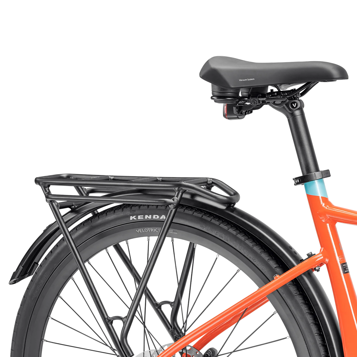 Close-up of the rear section of an orange Tampa Bay eBikes Velotric T1 Series bicycle, highlighting the eBike's seat, rear rack, fender, and wheel with visible Kenda tire branding.