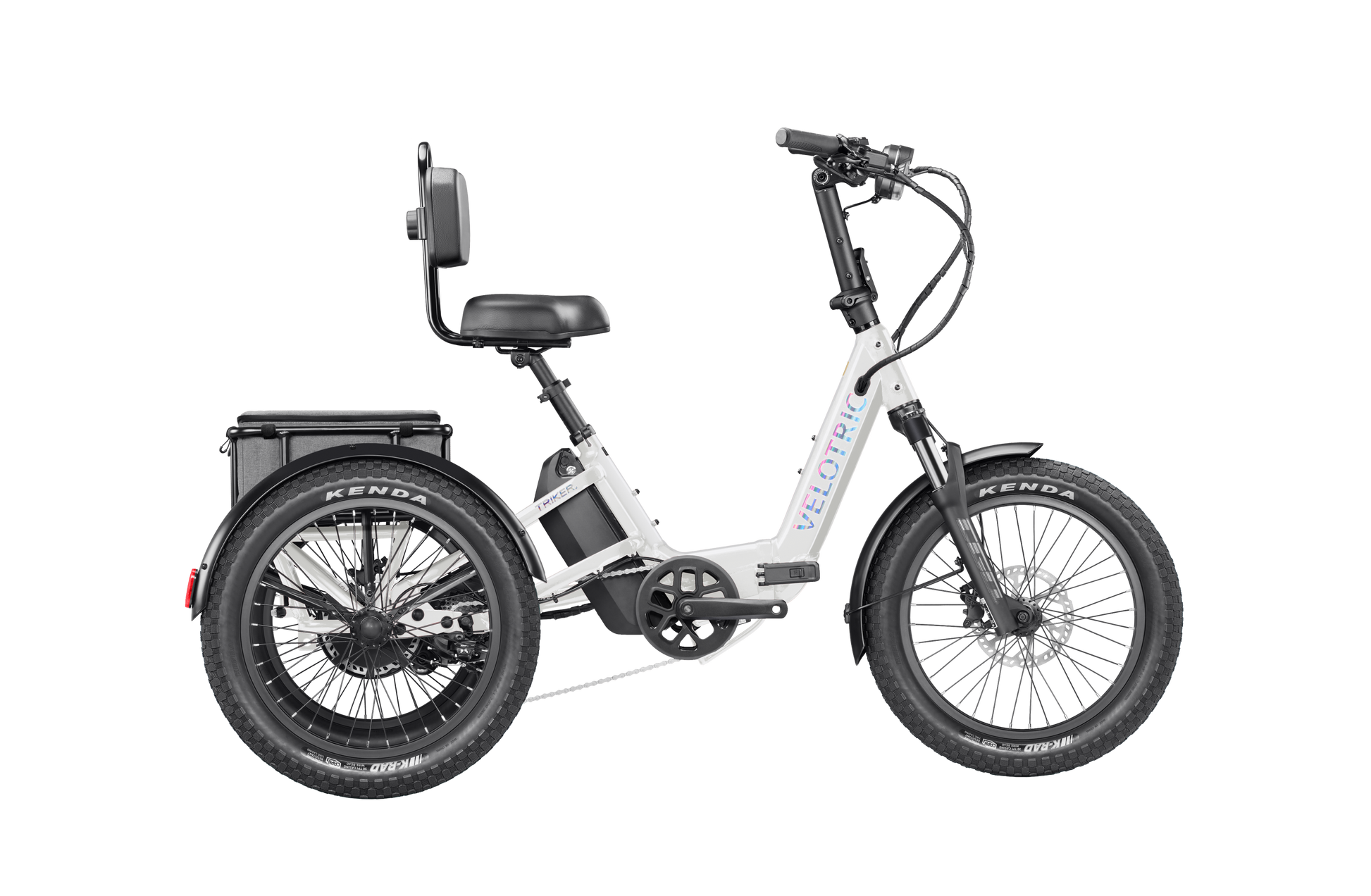 The Velotric Triker is a white three-wheeled urban eBike with large tires, a rear seat backrest, and an over-axle battery, powered by a 1,750W Velotric Breeze motor.