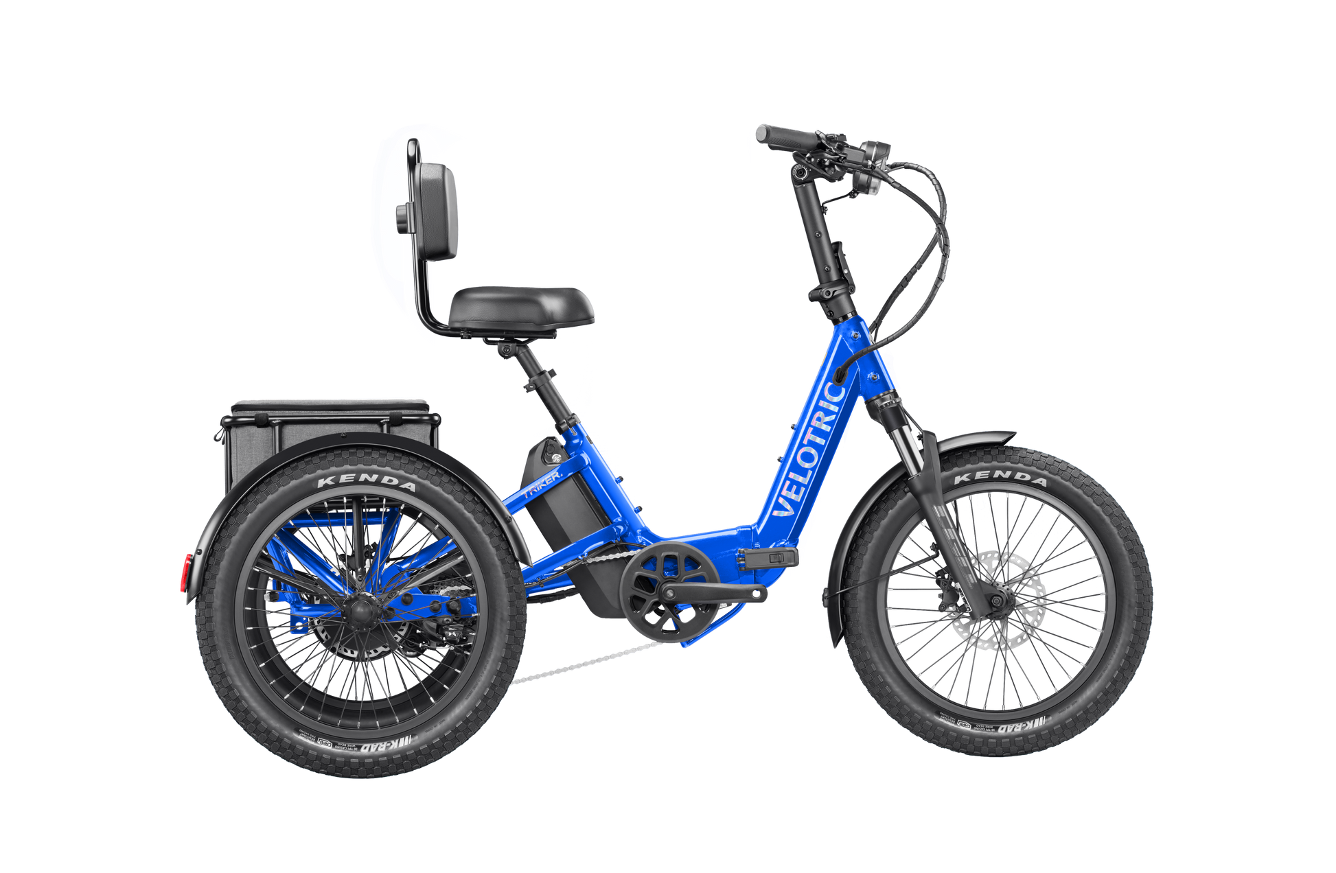 The Velotric Triker is a blue electric tricycle eBike featuring a 750W motor, backrest, wide seat, two rear wheels, thick Kenda tires, Shimano 8-speed drivetrain, and rear-mounted battery. The frame displays the Velotric brand name.