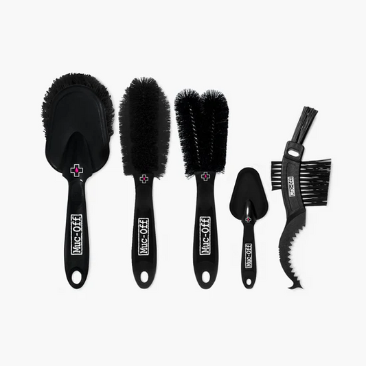 Set of five black cleaning brushes, including a Claw Brush and Soft Washing Brush, labeled "Muc-Off 5x Premium Brush Set," arranged side by side on a white background.