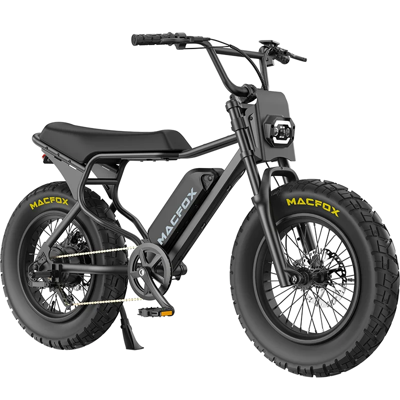 A black Macfox X7 retro-style eBike with thick tires, central battery, and wide handlebars. The Macfox brand is visible on the frame and tires in a white-background photo. Available at Tampa Bay eBikes.