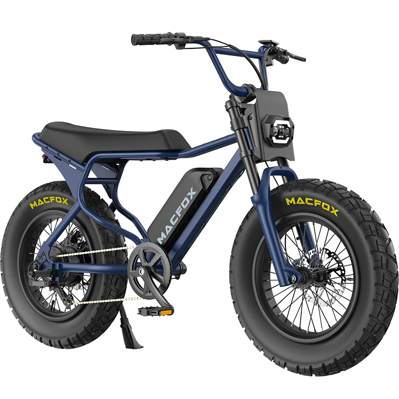 A blue retro moped-style eBike, the Macfox X7, features thick tires, a black seat, pedals, and "MACFOX" branding on both the tires and battery. Displayed by Tampa Bay eBikes against a white background.