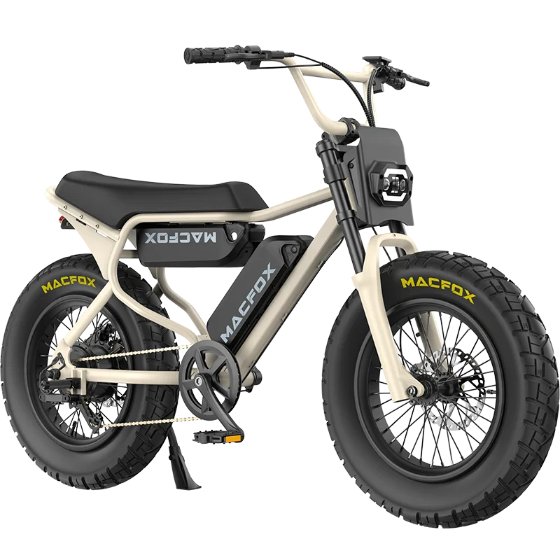 A beige Macfox X7 retro moped-style eBike with thick black tires, front headlight, and black seat is shown at a three-quarter angle on a white background. Available at Tampa Bay eBikes.