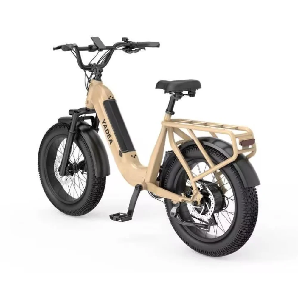 The Yadea - Camper is a beige electric bike designed with a robust frame, wide tires, and a rear rack. It features a 500W battery that is prominently mounted vertically on the frame and includes electric brakes for smooth stopping power.